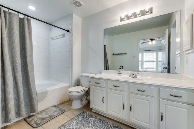 full bathroom featuring vanity, tile patterned flooring, toilet, shower / bath combo with shower curtain, and ceiling fan