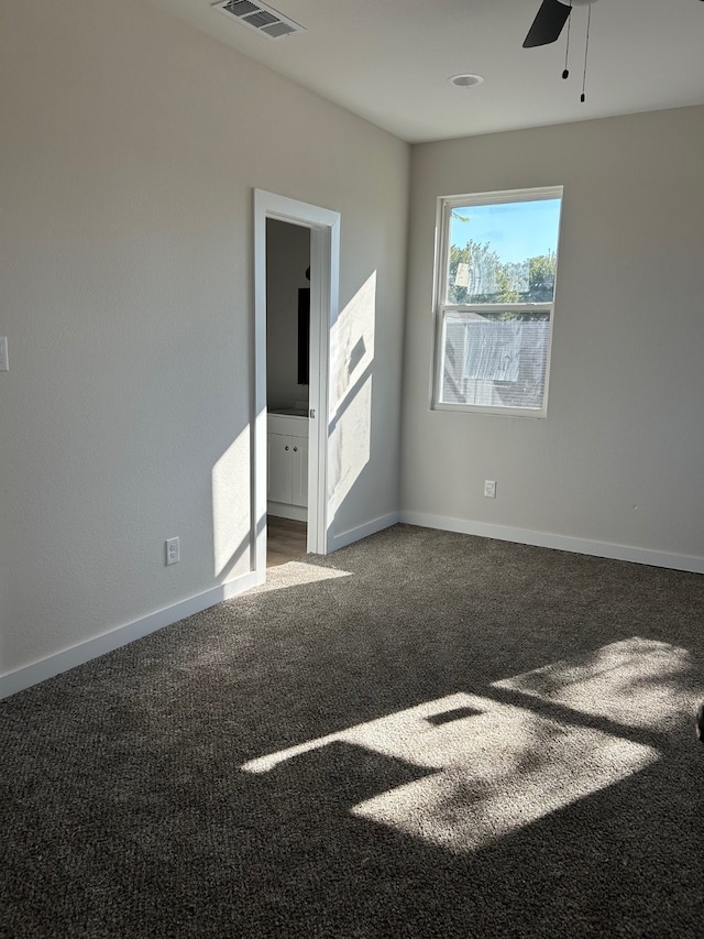 unfurnished room featuring ceiling fan and carpet flooring