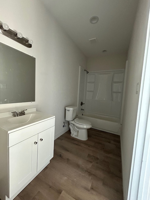 full bathroom with shower / bath combination, wood-type flooring, toilet, and vanity