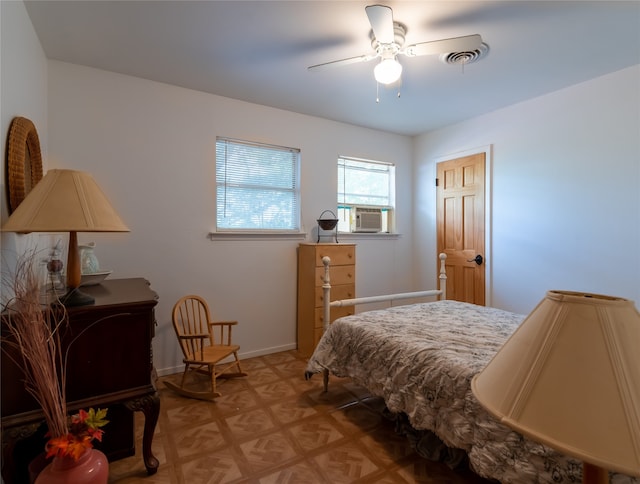 bedroom with cooling unit and ceiling fan