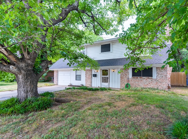 view of front of home with a garage and a front lawn