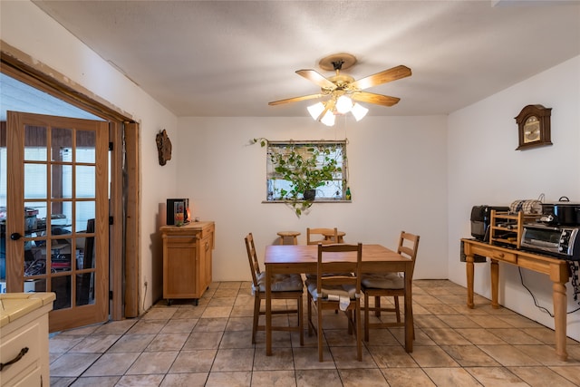 dining room with light tile patterned flooring and ceiling fan