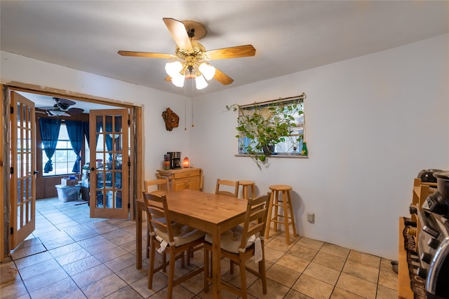 dining space with ceiling fan and french doors