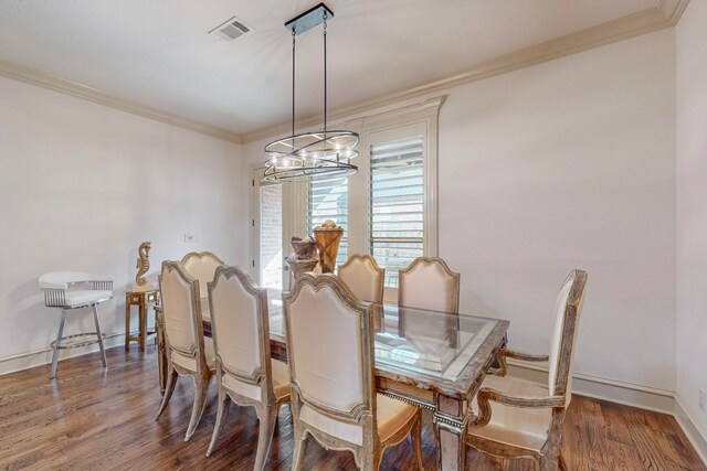 dining room featuring ornamental molding, dark wood-type flooring, and a notable chandelier