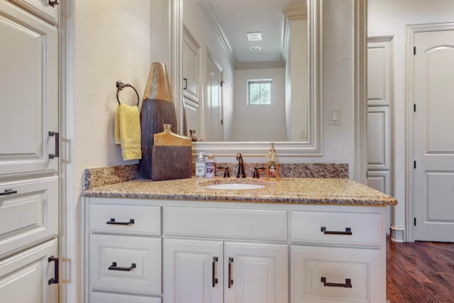 bathroom with hardwood / wood-style floors, vanity, and crown molding