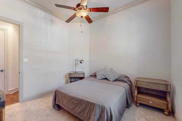 bedroom featuring ceiling fan, light carpet, and crown molding