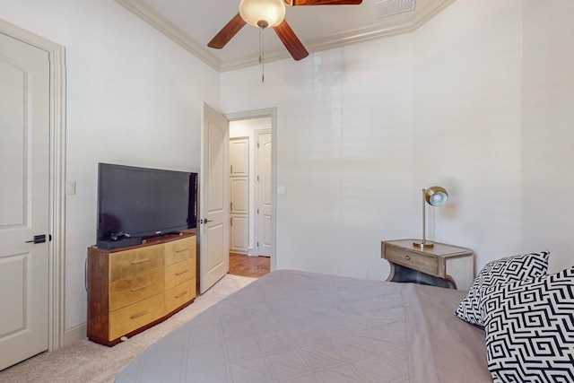 carpeted bedroom with ceiling fan and crown molding