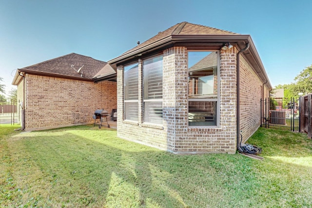 view of side of property with a lawn