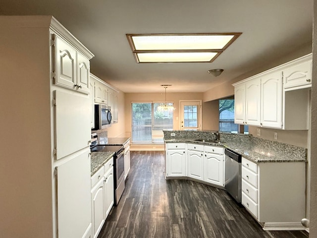 1501 Cat Mountain Trl, Keller, TX 76248 - kitchen featuring a sink, a peninsula, dark wood-type flooring, white cabinets, and appliances with stainless steel finishes