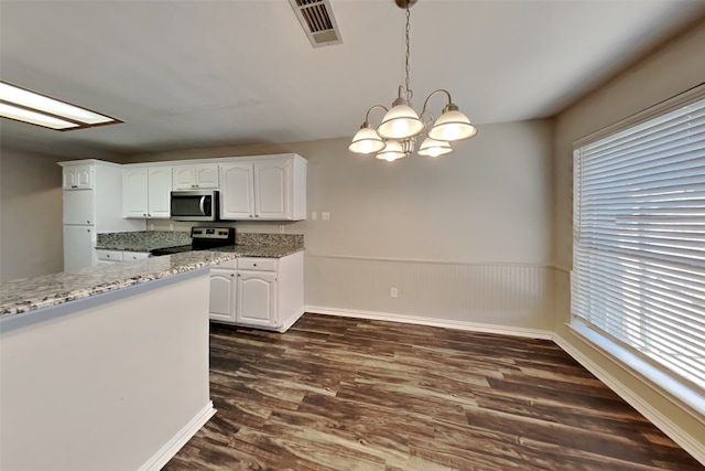 kitchen with white cabinets, stainless steel appliances, dark wood-type flooring, and decorative light fixtures