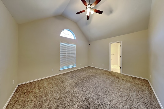 spare room with ceiling fan, vaulted ceiling, and carpet floors