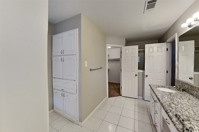 bathroom featuring tile patterned flooring and vanity