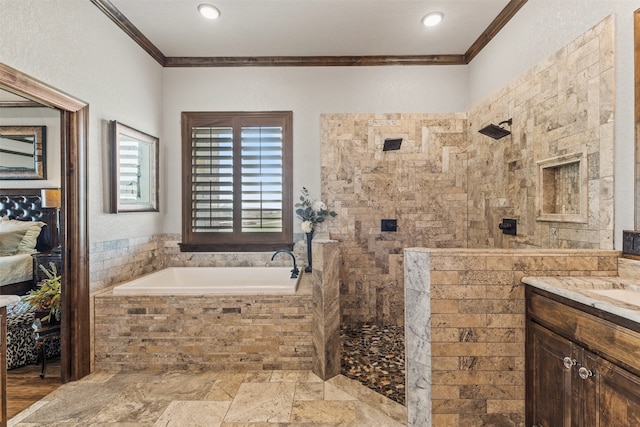 bathroom with vanity, a relaxing tiled tub, and crown molding