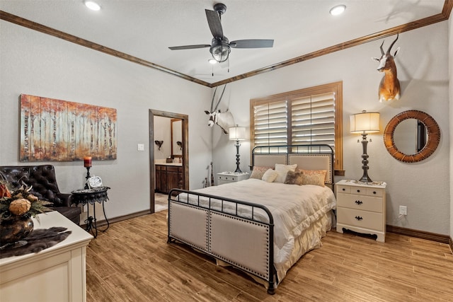 bedroom featuring ceiling fan, ensuite bath, light hardwood / wood-style flooring, and ornamental molding