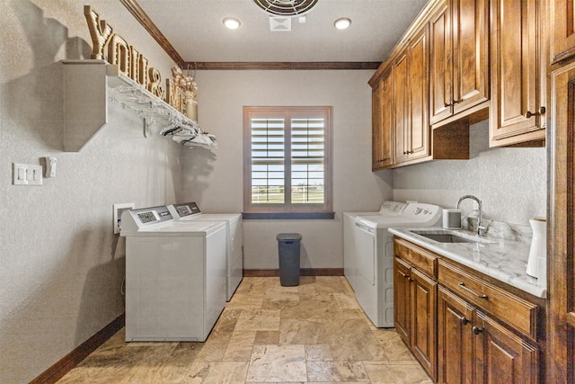 laundry area featuring cabinets, sink, crown molding, and independent washer and dryer