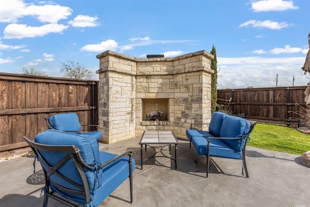 view of patio with an outdoor stone fireplace