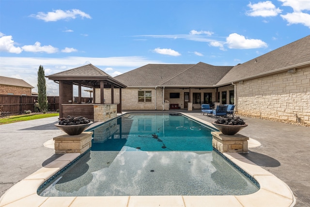 view of swimming pool featuring a patio area and a gazebo