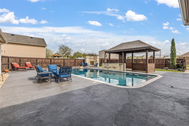 view of swimming pool featuring a patio area and a gazebo