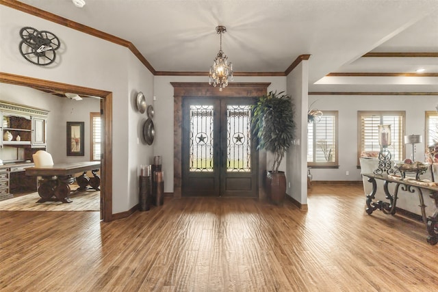 entryway featuring hardwood / wood-style flooring, crown molding, and french doors