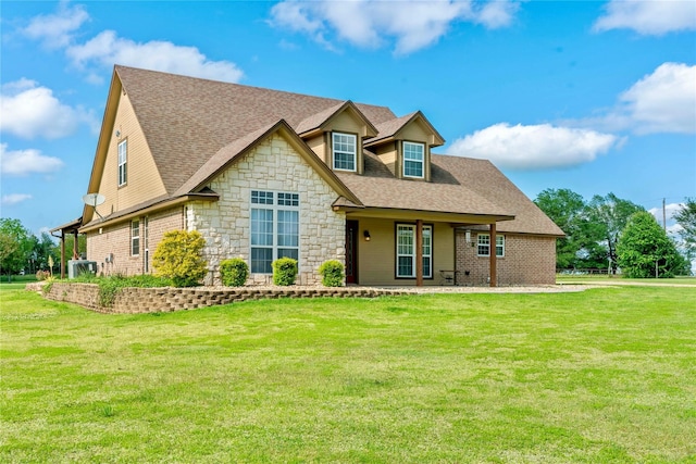 view of front facade featuring central AC unit, a front lawn, and a patio area