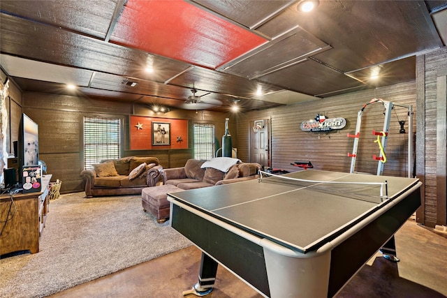 playroom featuring carpet flooring, wood walls, and ceiling fan