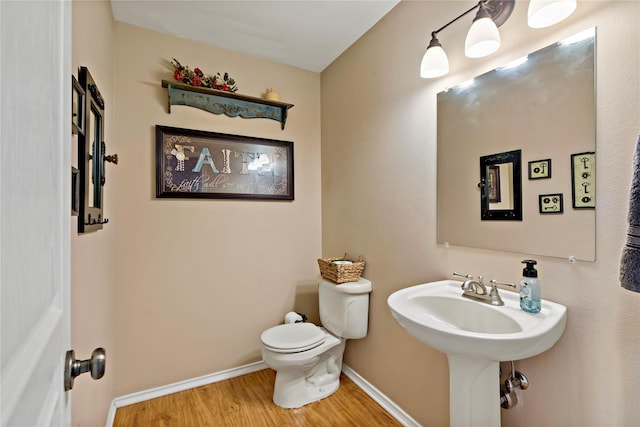 bathroom featuring hardwood / wood-style floors and toilet