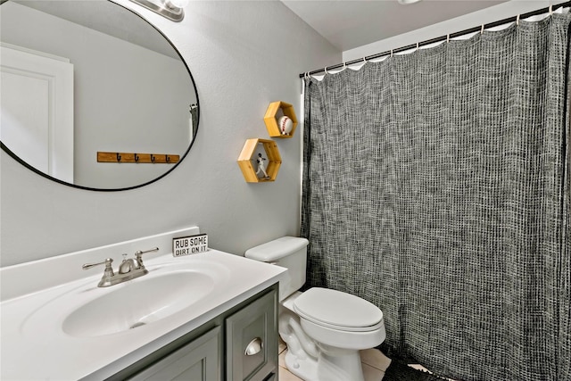 bathroom with curtained shower, tile patterned floors, vanity, and toilet