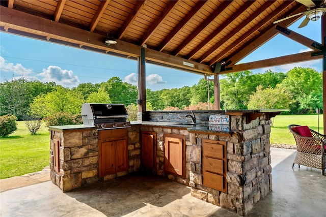 view of patio featuring grilling area, sink, an outdoor kitchen, and a gazebo