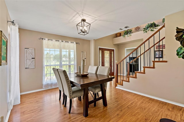 dining area featuring an inviting chandelier and light hardwood / wood-style floors