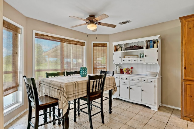 tiled dining room with ceiling fan