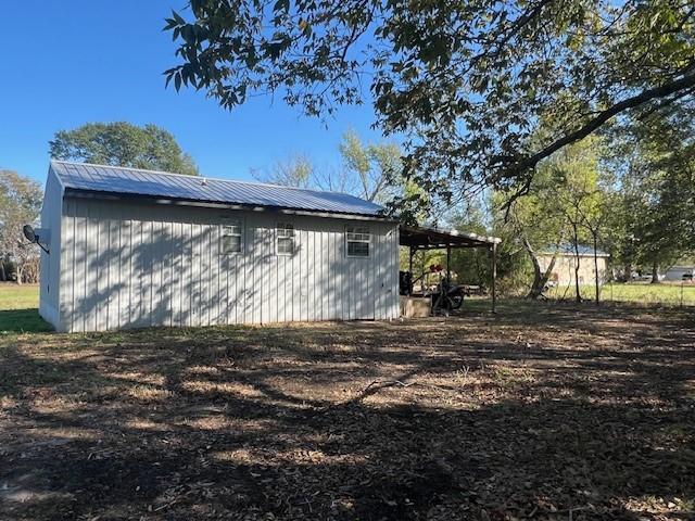 view of side of property featuring an outbuilding