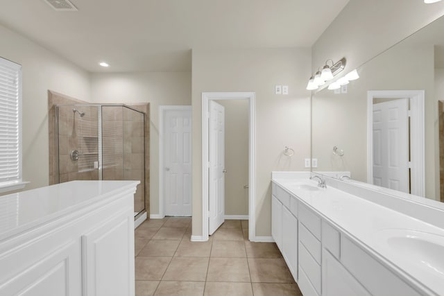 bathroom featuring a shower with door, vanity, and tile patterned floors