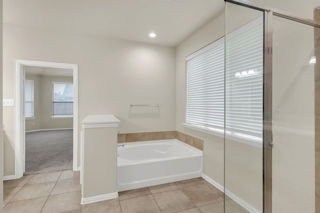 bathroom featuring tile patterned flooring and plus walk in shower