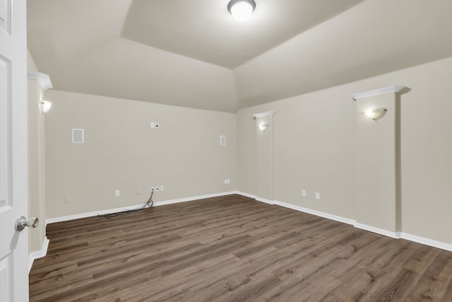 unfurnished room featuring lofted ceiling and dark hardwood / wood-style floors