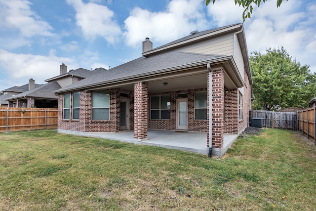 rear view of house with a patio, a lawn, and cooling unit