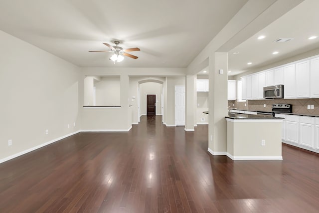 kitchen with dark hardwood / wood-style floors, white cabinetry, and appliances with stainless steel finishes