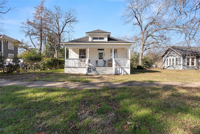 bungalow with a porch and a front yard