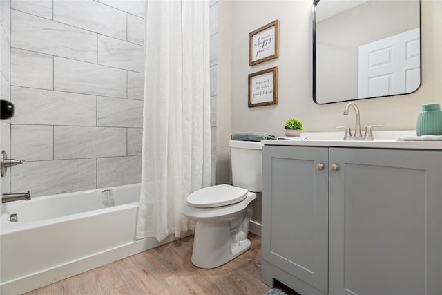 full bathroom with vanity, hardwood / wood-style floors, toilet, and shower / bath combo