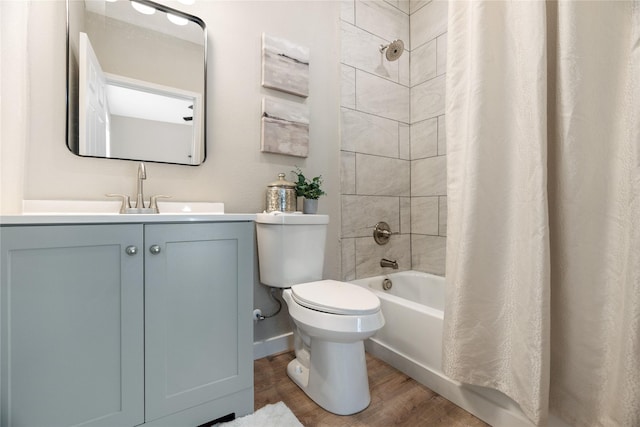 full bathroom featuring hardwood / wood-style flooring, shower / bathtub combination with curtain, vanity, and toilet