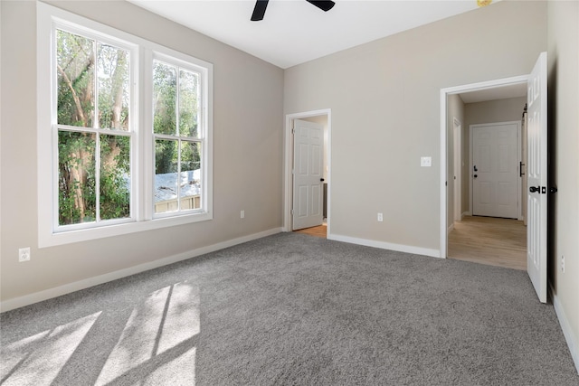 unfurnished bedroom featuring light colored carpet and ceiling fan