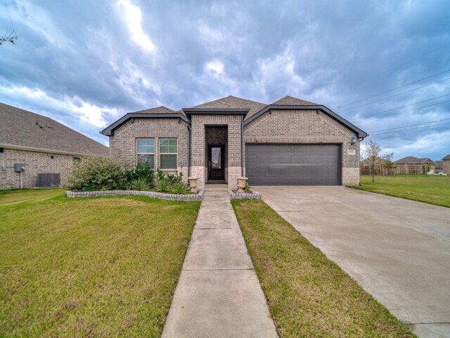 view of front of property with a front lawn and a garage