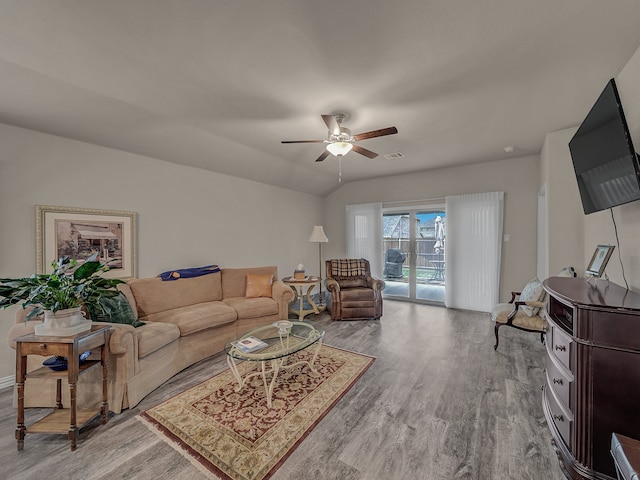 living room featuring hardwood / wood-style flooring and ceiling fan