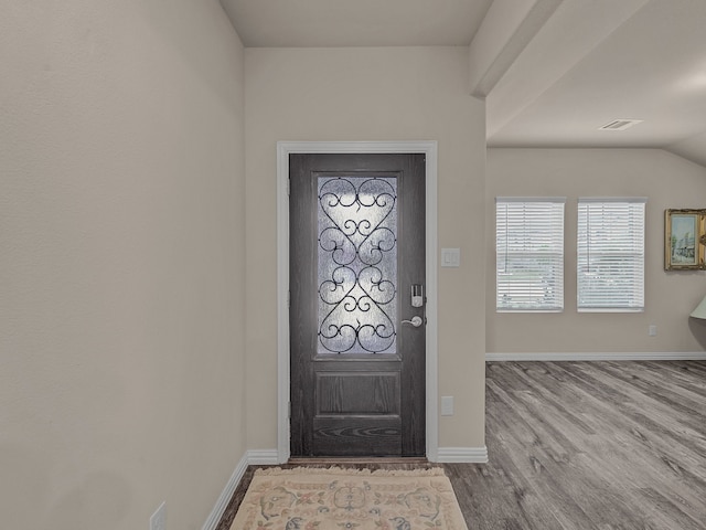 foyer featuring light wood-type flooring and lofted ceiling