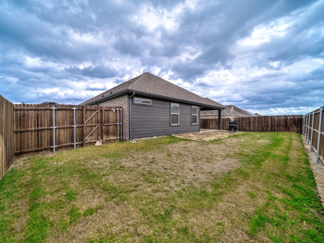 rear view of property with a yard