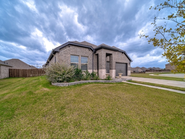 view of front of home with a garage and a front lawn