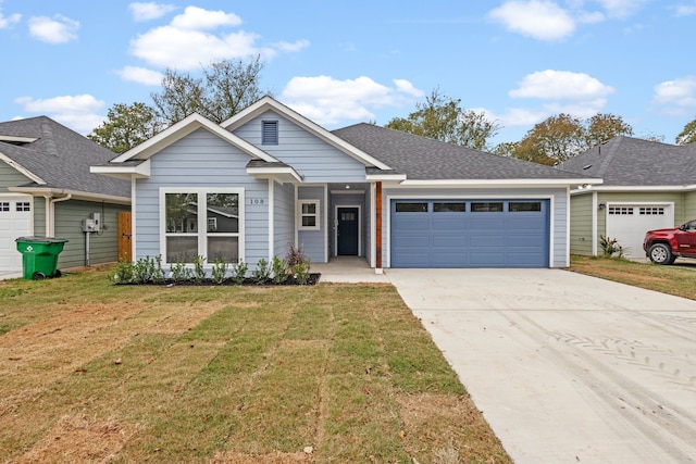 view of front of house with a garage and a front lawn