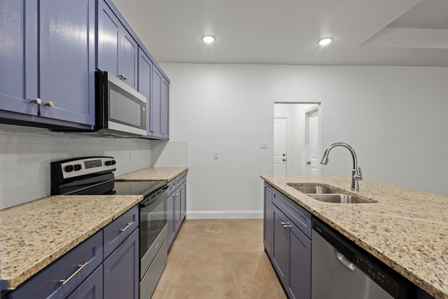 kitchen with stainless steel appliances, blue cabinetry, light stone countertops, sink, and decorative backsplash