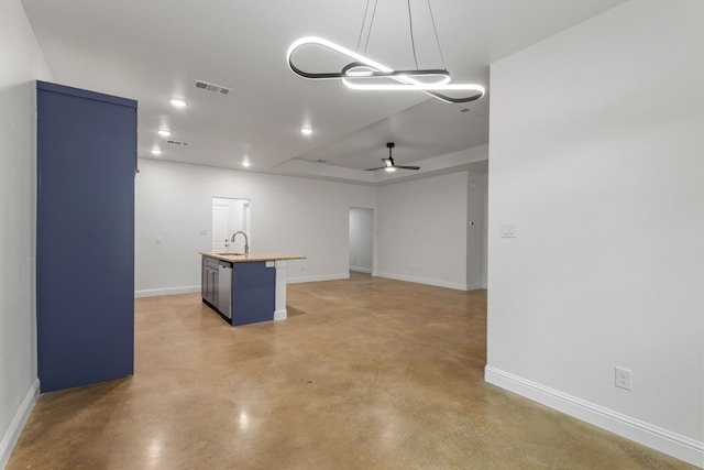 interior space featuring ceiling fan, sink, and a tray ceiling