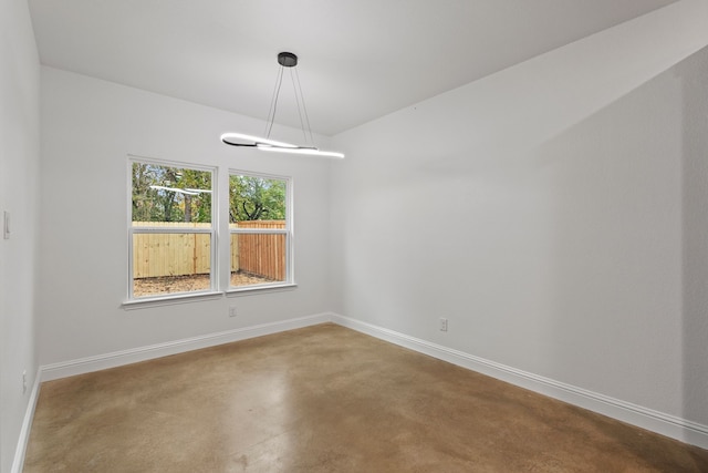 unfurnished room featuring concrete flooring