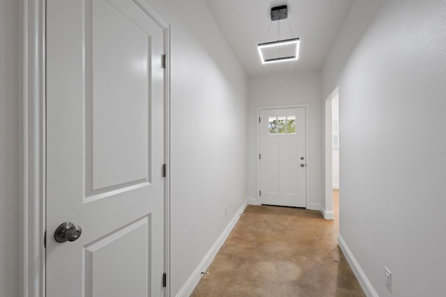 doorway to outside featuring light colored carpet